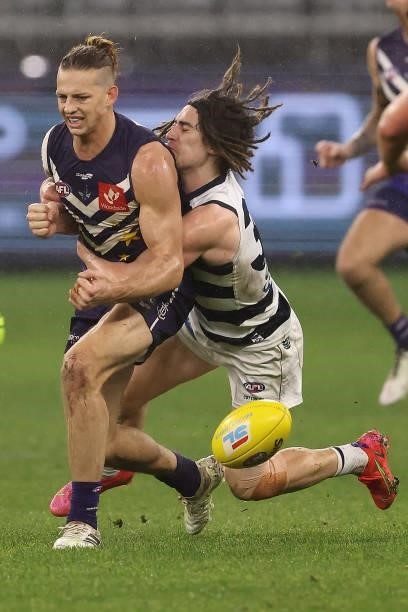 Nat Fyfe of the Dockers gets tackled by Gryan Miers of the Cats during the round 18 AFL match between the Fremantle Dockers and Geelong Cats at Optus...