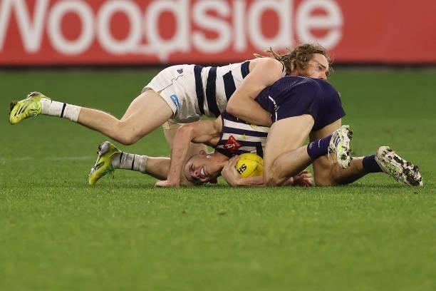 Cameron Guthrie of the Cats tackles Nat Fyfe of the Dockers during the round 18 AFL match between the Fremantle Dockers and Geelong Cats at Optus...