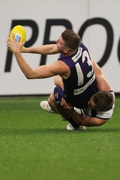 Luke Ryan of the Dockers gets tackled by Shaun Higgins of the Cats during the round 18 AFL match between the Fremantle Dockers and Geelong Cats at...