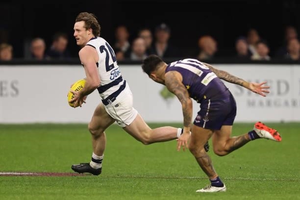 Jed Bews of the Cats runs onto a loose ball against Michael Walters of the Dockers during the round 18 AFL match between the Fremantle Dockers and...