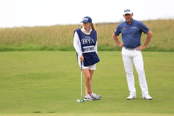 Lee Westwood of England and his caddie, Helen Storey look on from the green of the 16th hole during Day One of The 149th Open at Royal St George’s...