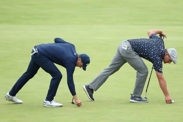 Jordan Speith and Bryson Dechambeau of The United States prepare to putt on the 18th green during Day One of The 149th Open at Royal St George’s Golf...