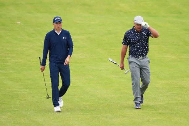 Jordan Spieth of the United States and Bryson DeChambeau of the United States speak as they walk down the 18th hole during Day One of The 149th Open...