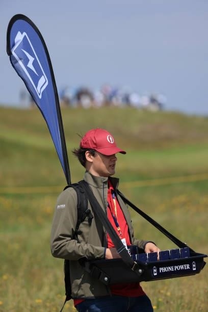 An official offering phone charging is seen during Day One of The 149th Open at Royal St George’s Golf Club on July 15, 2021 in Sandwich, England.