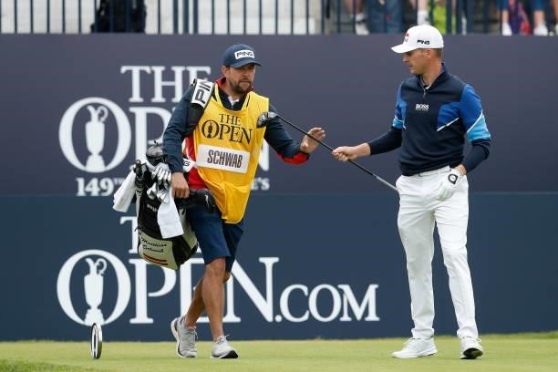 Matthias Schwab of Austria passes his driver back to his caddie after playing his shot from the first tee during Day One of The 149th Open at Royal...