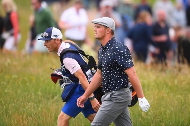 Bryson Dechambeau of The United States and caddie walk on the 17th hole during Day One of The 149th Open at Royal St George’s Golf Club on July 15,...