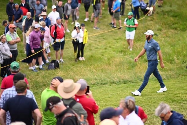 Dustin Johnson of The United States walks past spectators on the 16th hole during Day One of The 149th Open at Royal St George’s Golf Club on July...