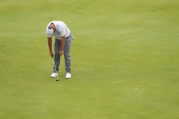 Dustin Johnson of the United States reacts on the green of the 18th hole during Day One of The 149th Open at Royal St George’s Golf Club on July 15,...