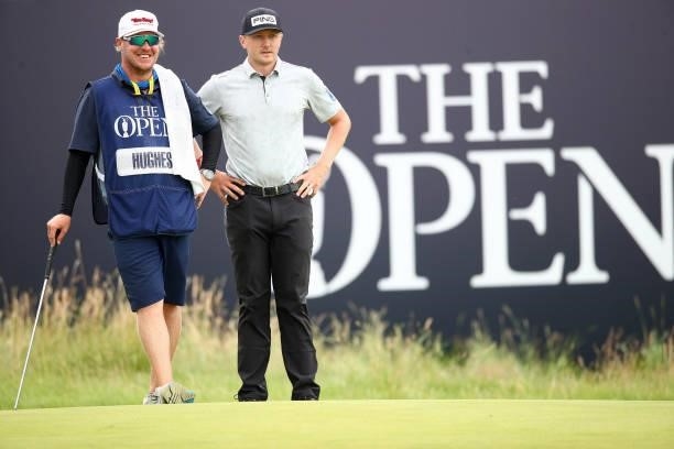 Mackenzie Hughes of Canada and his caddie look on from the green of the 18th hole during Day One of The 149th Open at Royal St George’s Golf Club on...