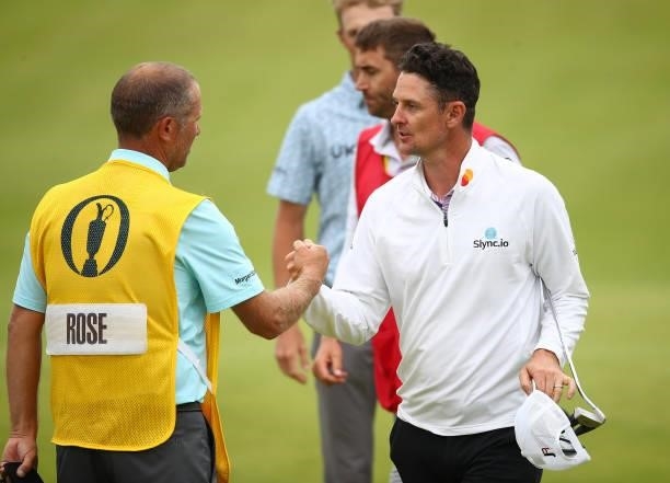 Justin Rose of England bumps fists with his caddie after his round during Day One of The 149th Open at Royal St George’s Golf Club on July 15, 2021...