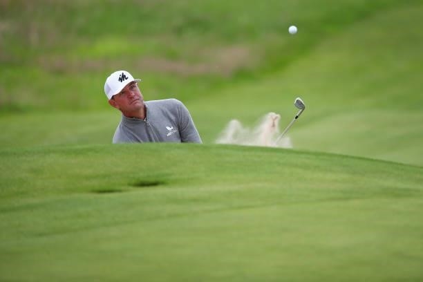 Lucas Glover of the United States plays a bunker shot on the 18th hole during Day One of The 149th Open at Royal St George’s Golf Club on July 15,...