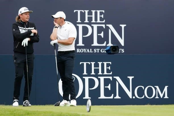 Rory McIlroy of Northern Ireland interacts with Cameron Smith of Australia at the tee of the first hole during Day One of The 149th Open at Royal St...