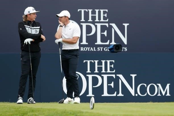 Rory McIlroy of Northern Ireland interacts with Cameron Smith of Australia at the tee of the first hole during Day One of The 149th Open at Royal St...