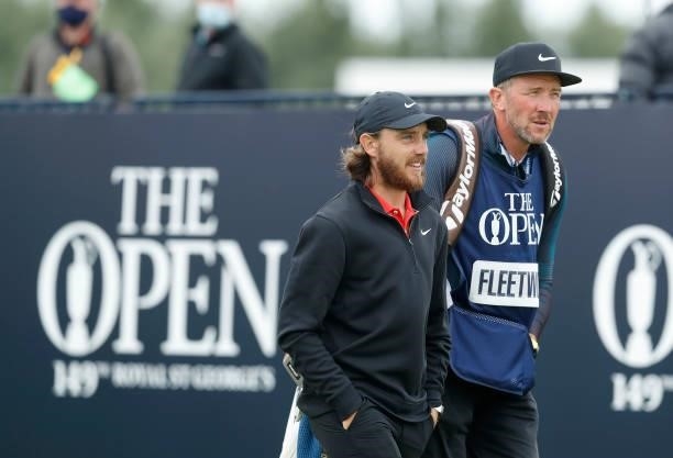 Tommy Fleetwood of England interacts with his caddie, Ian Finnis on the 1 during Day One of The 149th Open at Royal St George’s Golf Club on July 15,...