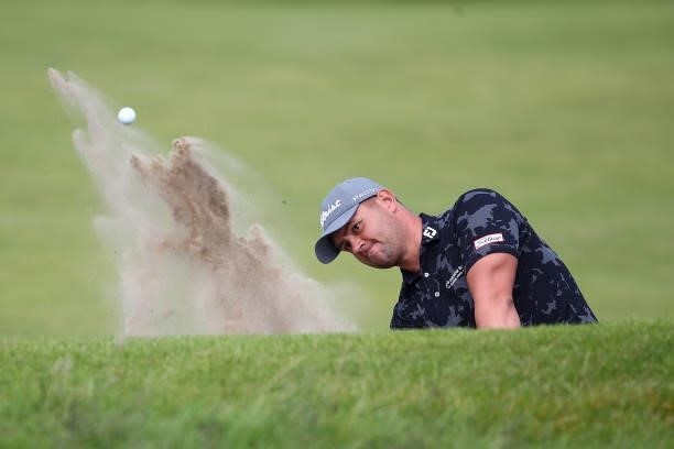 Daniel van Tonder of South Africa plays his second shot from the bunker on the 18th hole during Day One of The 149th Open at Royal St George’s Golf...