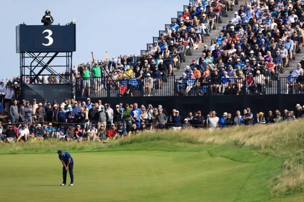 Patrick Reed of the United States putts on the third green as a gallery of fans look on during Day One of The 149th Open at Royal St George’s Golf...