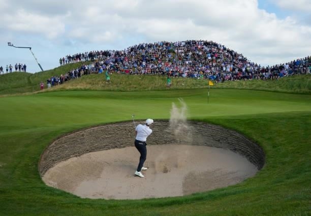 Rory McIlroy of Northern Ireland plays a bunker shot on the sixth hole during Day One of The 149th Open at Royal St George’s Golf Club on July 15,...
