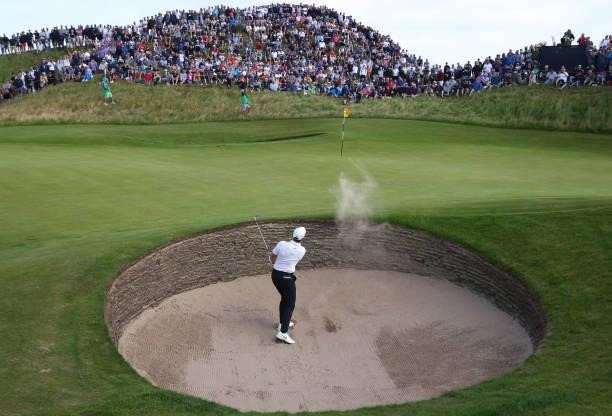Rory McIlroy of Northern Ireland plays out of a bunker onto the 8th green during Day One of The 149th Open at Royal St George’s Golf Club on July 15,...