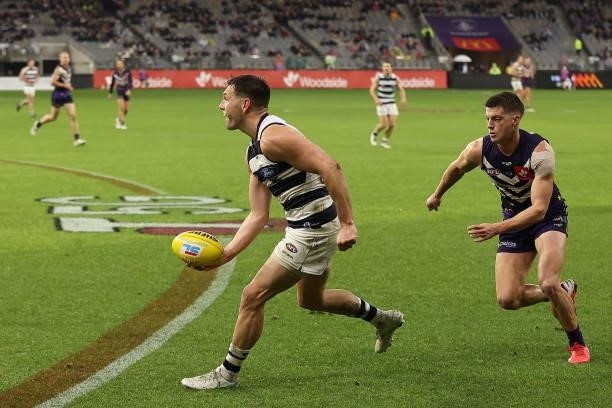 Shaun Higgins of the Cats looks to handball during the round 18 AFL match between the Fremantle Dockers and Geelong Cats at Optus Stadium on July 15,...