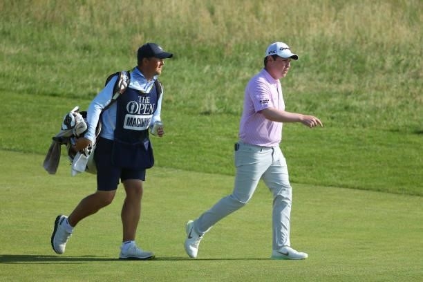 Robert MacIntyre of Scotland and his caddie walk the ninth hole during Day One of The 149th Open at Royal St George’s Golf Club on July 15, 2021 in...