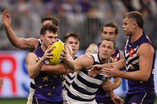 Blake Acres of the Dockers gets tackled during the round 18 AFL match between the Fremantle Dockers and Geelong Cats at Optus Stadium on July 15,...