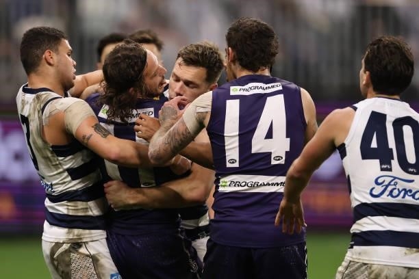James Aish of the Dockers gets tackled during the round 18 AFL match between the Fremantle Dockers and Geelong Cats at Optus Stadium on July 15, 2021...