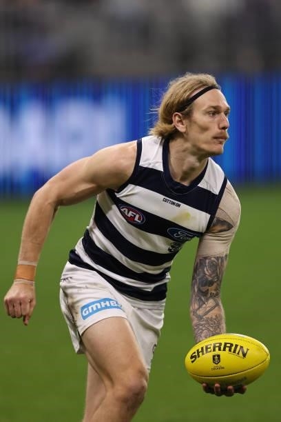 Tom Stewart of the Cats looks to handball during the round 18 AFL match between the Fremantle Dockers and Geelong Cats at Optus Stadium on July 15,...
