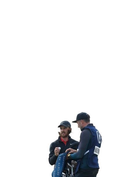 Tommy Fleetwood of England speaks with his caddie, Ian Finnis on the green of the tenth hole during Day One of The 149th Open at Royal St George’s...