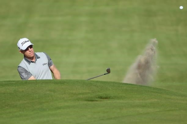 Brad Kennedy of Australia plays out of a bunker on the 18th hole during Day One of The 149th Open at Royal St George’s Golf Club on July 15, 2021 in...