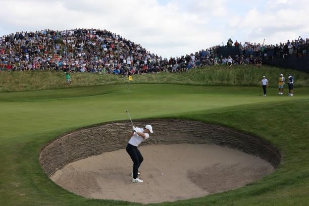 Rory McIlroy of Northern Ireland plays out of a bunker onto the 8th green during Day One of The 149th Open at Royal St George’s Golf Club on July 15,...