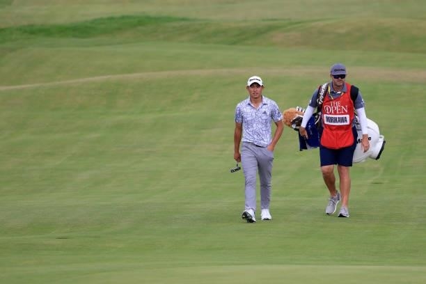 Collin Morikawa of the United States and caddie Jonathan Jakovac walk the 18th hole during Day One of The 149th Open at Royal St George’s Golf Club...