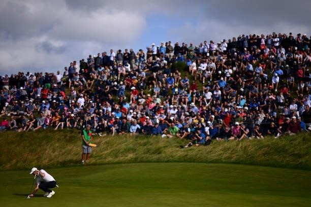 Rory McIlroy of Northern Ireland lines up a putt on the 6th green during Day One of The 149th Open at Royal St George’s Golf Club on July 15, 2021 in...