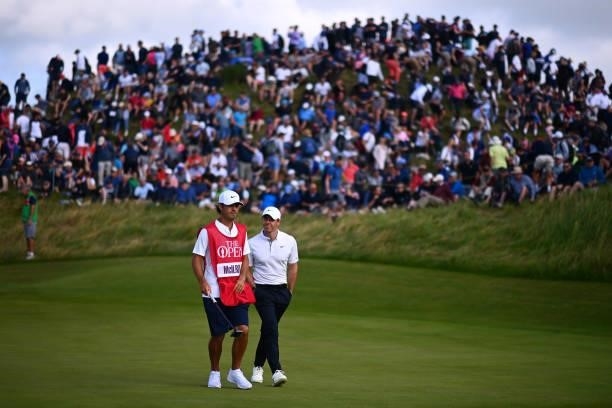 Rory McIlroy of Northern Ireland and caddie Harry Diamond walk from the 6th green during Day One of The 149th Open at Royal St George’s Golf Club on...