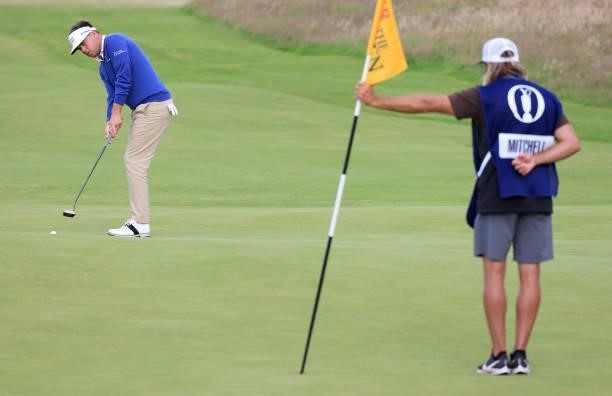 Keith Mitchell of the United States putts for birdie as his caddie holds the flag on the 18th green during Day One of The 149th Open at Royal St...