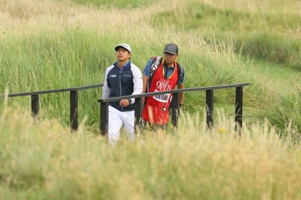 Kurt Kitayama of the United States walks with his caddie on the tenth hole during Day One of The 149th Open at Royal St George’s Golf Club on July...