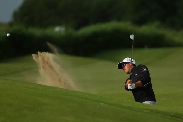 Rickie Fowler of the United States plays a shot from a bunker on the 14th hole during Day One of The 149th Open at Royal St George’s Golf Club on...