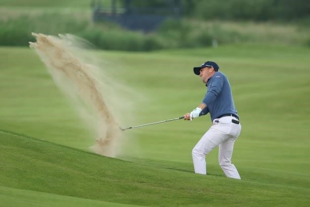 Justin Thomas of the United States plays a shot from a bunker on the 14th hole during Day One of The 149th Open at Royal St George’s Golf Club on...