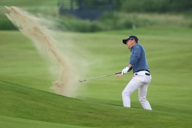 Justin Thomas of the United States plays a shot from a bunker on the 14th hole during Day One of The 149th Open at Royal St George’s Golf Club on...