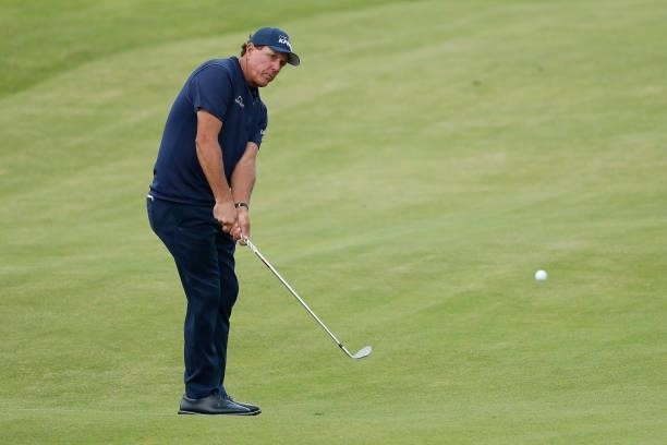 Phil Mickelson of the United States chips to the 18th green during Day One of The 149th Open at Royal St George’s Golf Club on July 15, 2021 in...