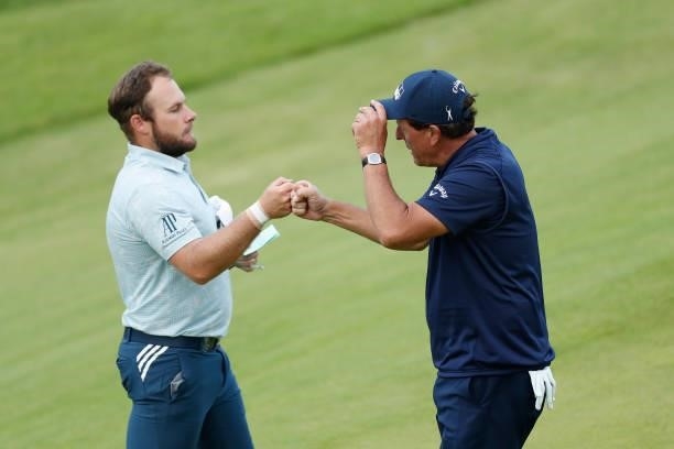 Tyrrell Hatton of England and Phil Mickelson of the United States fist bump on the 18th green during Day One of The 149th Open at Royal St George’s...