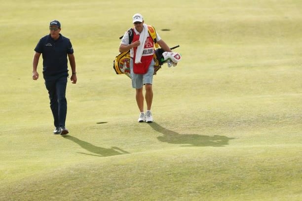 Phil Mickelson of the United States and caddie Tim Mickelson walk the 15th hole during Day One of The 149th Open at Royal St George’s Golf Club on...