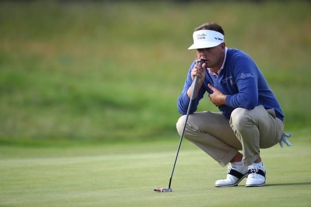 Keith Mitchell of USA lines up a putt of the 16th during Day One of The 149th Open at Royal St George’s Golf Club on July 15, 2021 in Sandwich,...