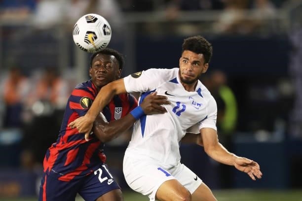 Emmanuel Riviere of Martinique and George Bello of United States fight for the ball during a Group B match as part of 2021 the CONCACAF Gold Cup at...