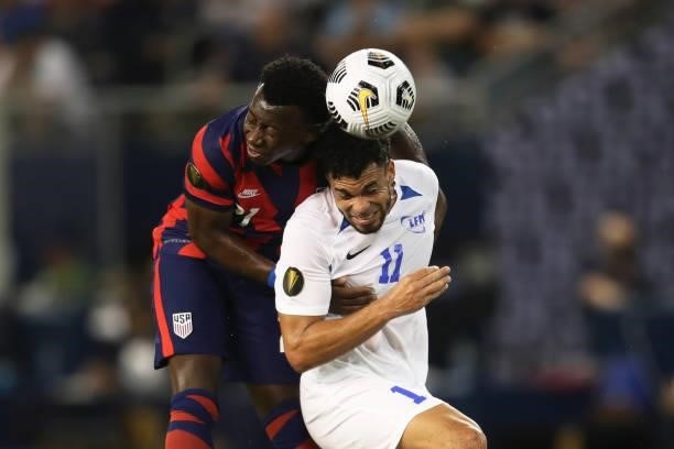 Emmanuel Riviere of Martinique and George Bello of the United States head the ball during a Group B match as part of the 2021 CONCACAF Gold Cup at...