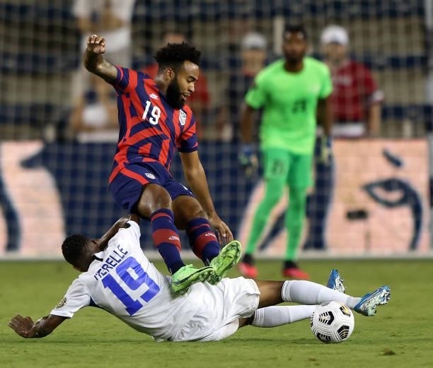 Eryk Williamson of the Zunited States is upended by Daniel Herelle of Martinique during the 2021 CONCACAF Gold Cup match at Children's Mercy Park on...