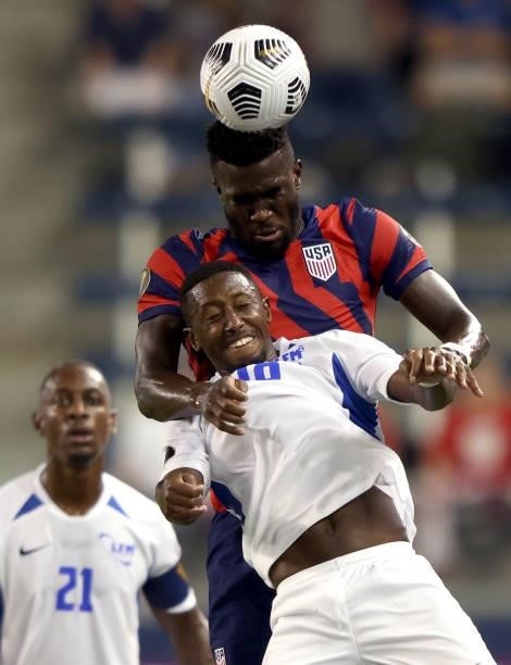 Daryl Dike beats Samuel Camille of Martinique for a head ball during the 2021 CONCACAF Gold Cup match at Children's Mercy Park on July 15, 2021 in...