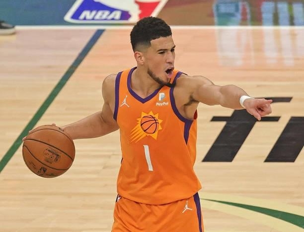 Devin Booker of the Phoenix Suns directs his team against the Milwaukee Bucks at Fiserv Forum on July 14, 2021 in Milwaukee, Wisconsin. The Bucks...