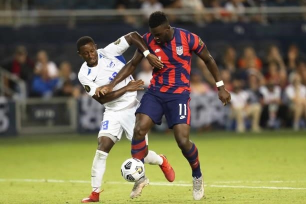 Daryl Dike of United States and Samuel Camille of Martinique fight for the ball during a Group B match as part of the 2021 CONCACAF Gold Cup at...