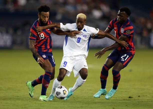 Reuperne Enrick of Martinique controls the ball as Eryk Williamson and George Bello of the United States defend during the 2021 CONCACAF Gold Cup...
