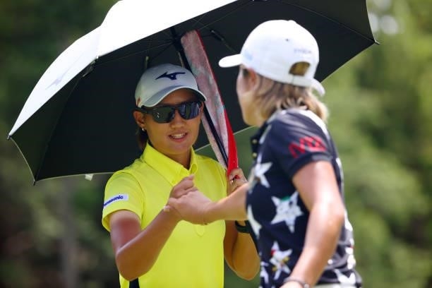 Mao Nozawa and Asako Fujimoto of Japan fist bump after holing out on the 9th green during first round of the GMO Internet Ladies Samantha Thavasa...